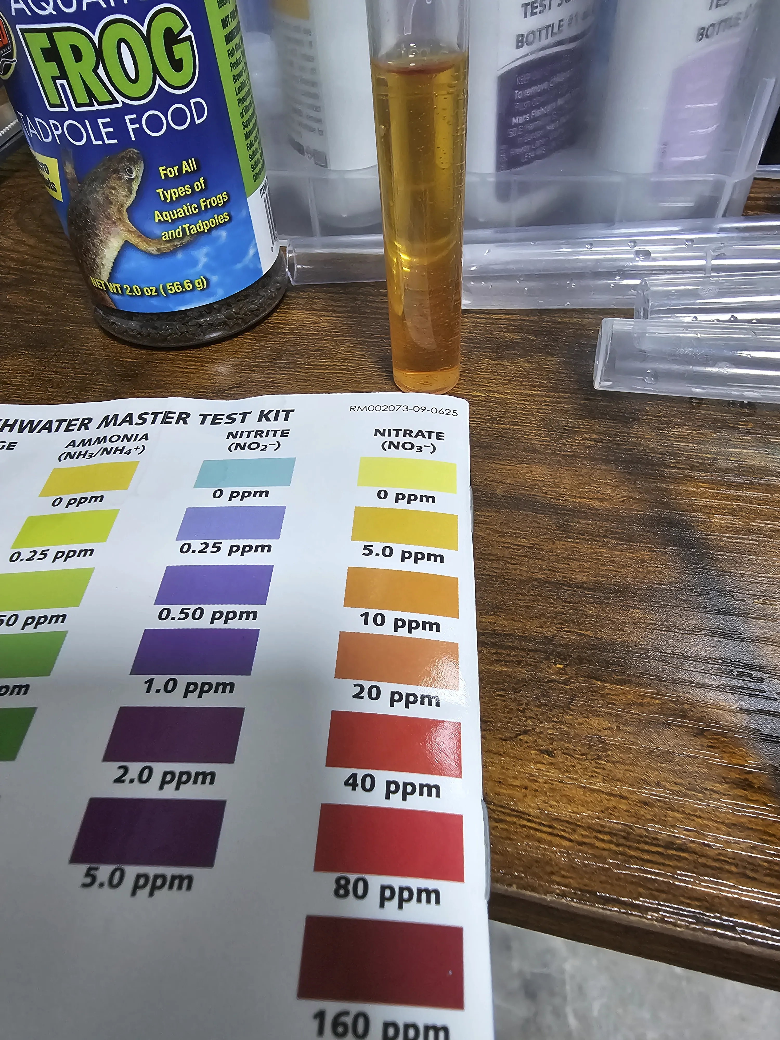 lighter orange test tube indicate that nitrates went down to approximately 6 ppm after water change